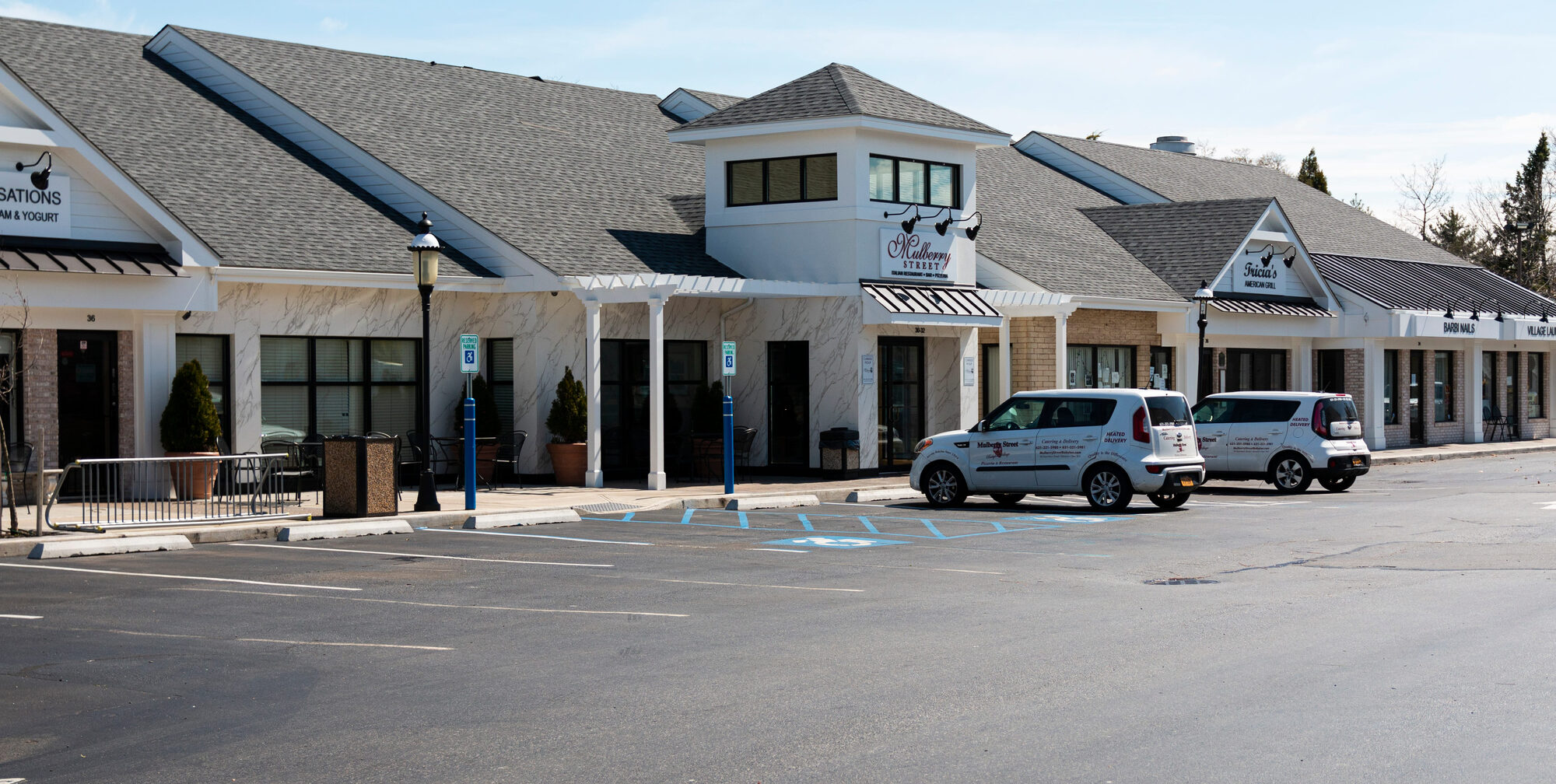 Exterior of a commercial strip mall building with a low-slope roof